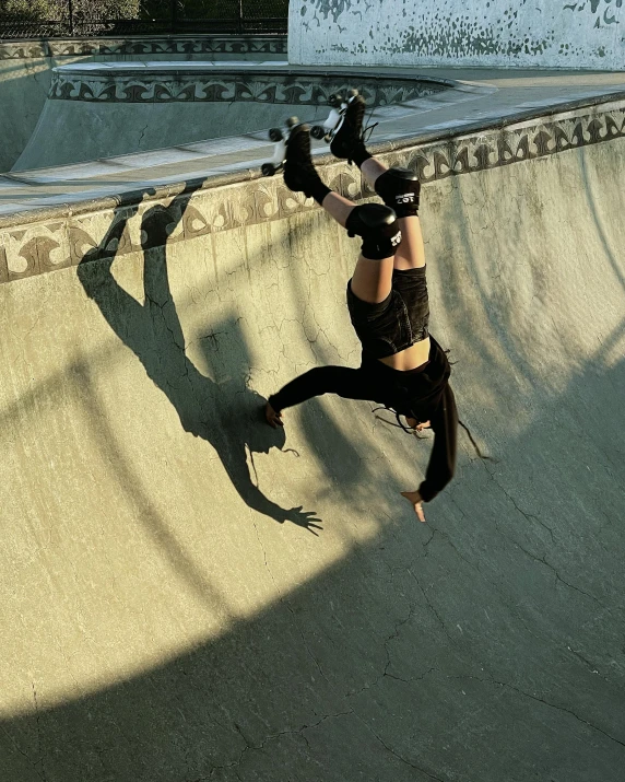 a man riding a skateboard up the side of a ramp, by Grace Polit, arabesque, an epic non - binary model, hanging upside down, instagram photo, no cropping