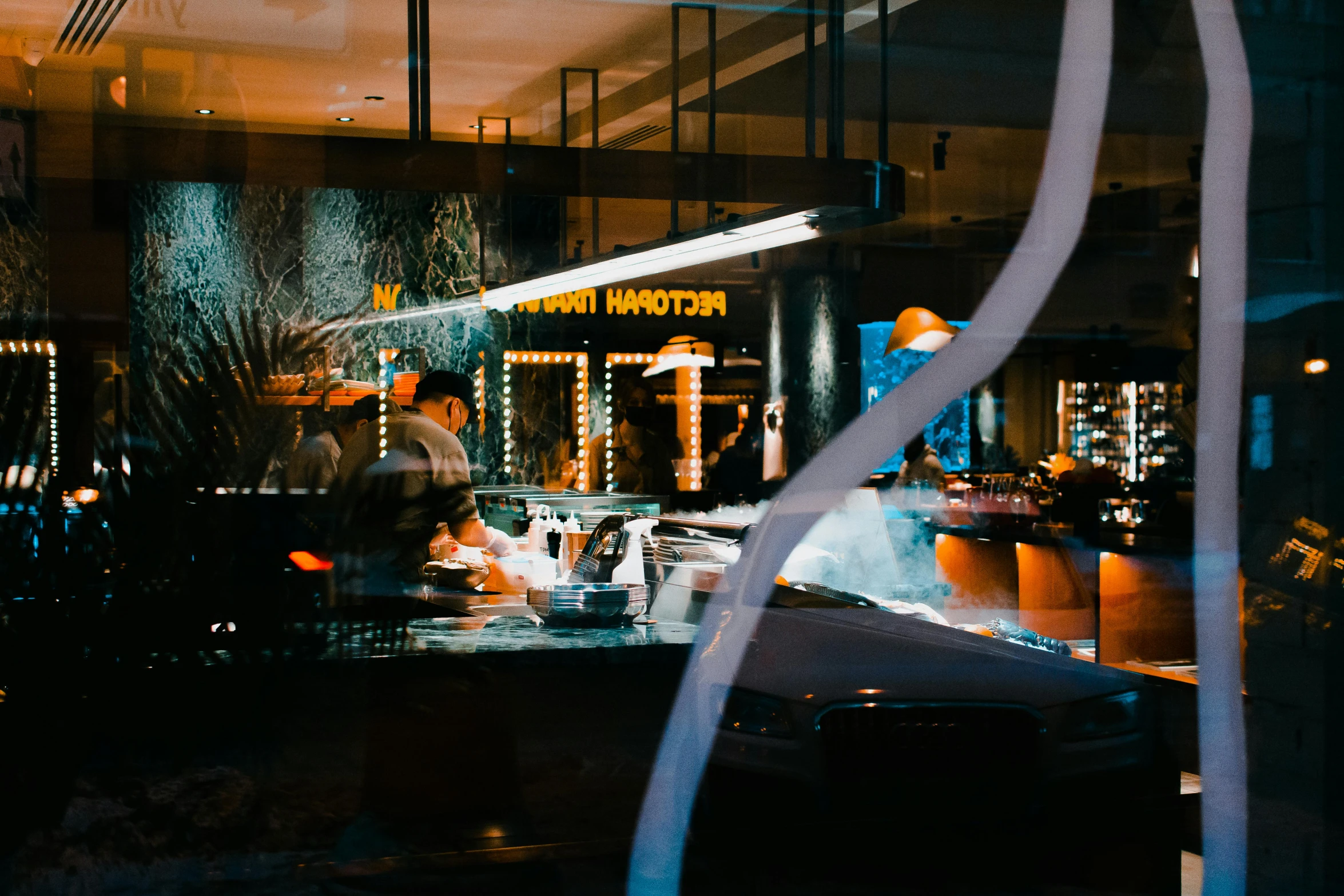 a couple of people that are standing in front of a window, by Lee Loughridge, pexels contest winner, nighthawks, gourmet michelin restaurant, car shot, glowing reflections