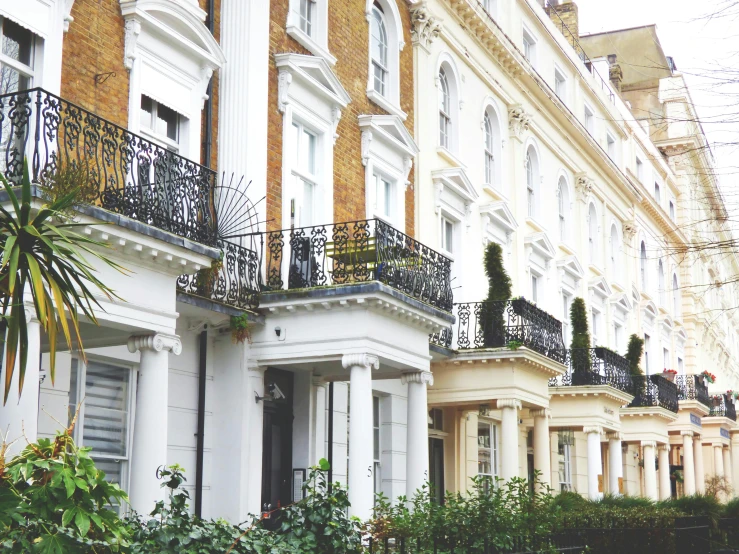a row of houses with balconies on the balconies, by Rachel Reckitt, unsplash, neoclassicism, square, lawn, nineteenth century london, victorian arcs of sand