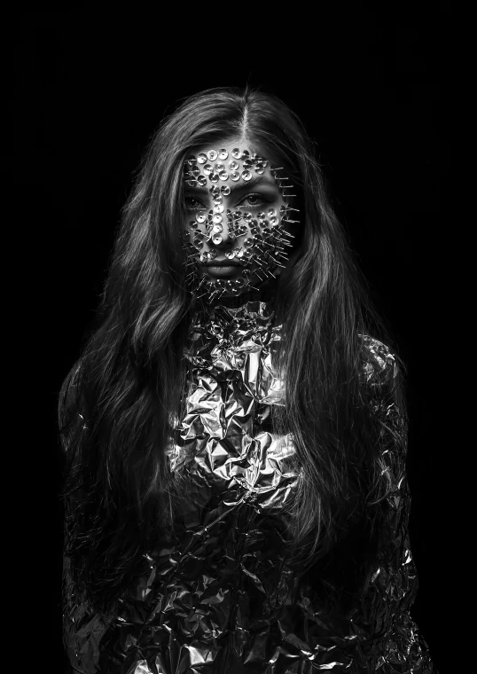 a black and white photo of a woman covered in foil, inspired by Hedi Xandt, tumblr, hyperrealism, [ metal ], black metal, reptilian, burnt armor