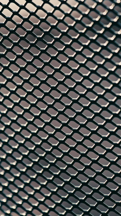 a close up of a piece of metal mesh, an album cover, pexels, birdseye view, 256435456k film, black, snake