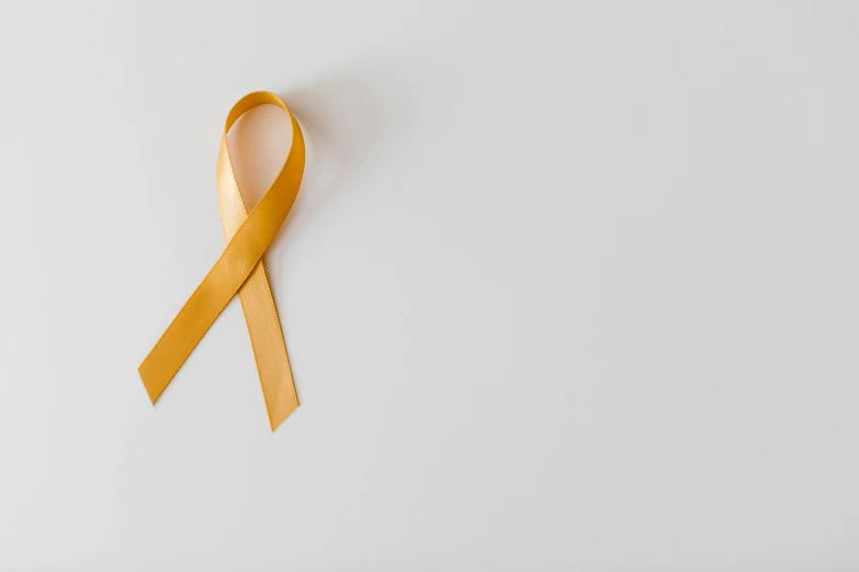 a yellow ribbon on a white background, by Carey Morris, pexels, hurufiyya, agent orange, instagram post, medical, background image