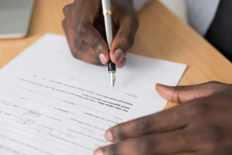 a person signing a document with a pen, thumbnail, background image, multiple stories, épaule devant pose