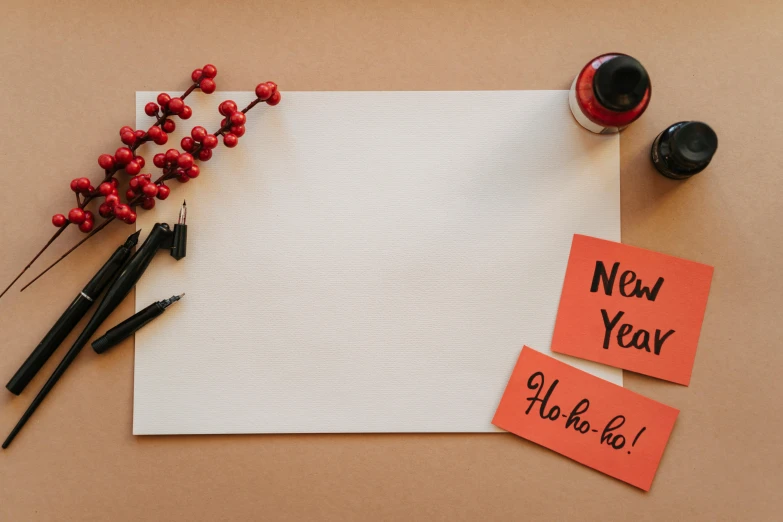 a piece of paper sitting on top of a table, trending on pexels, new objectivity, new years eve, red ink, background image, various items