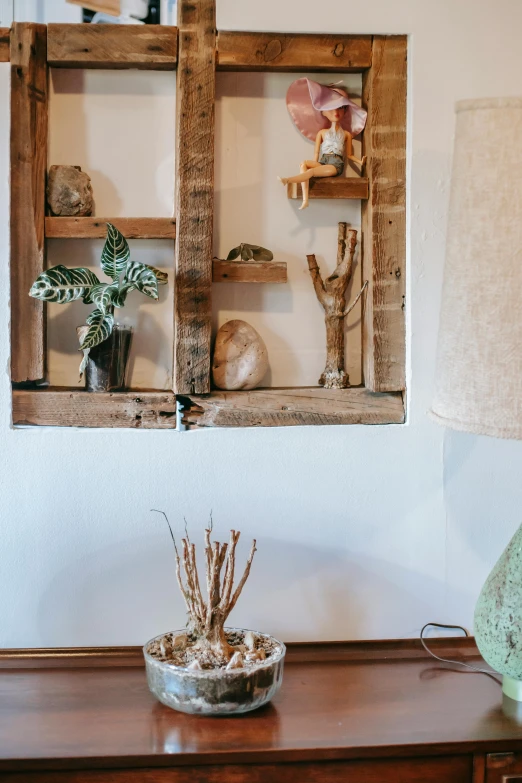 a lamp sitting on top of a wooden table, jar on a shelf, jewelry display, storefront, wall art