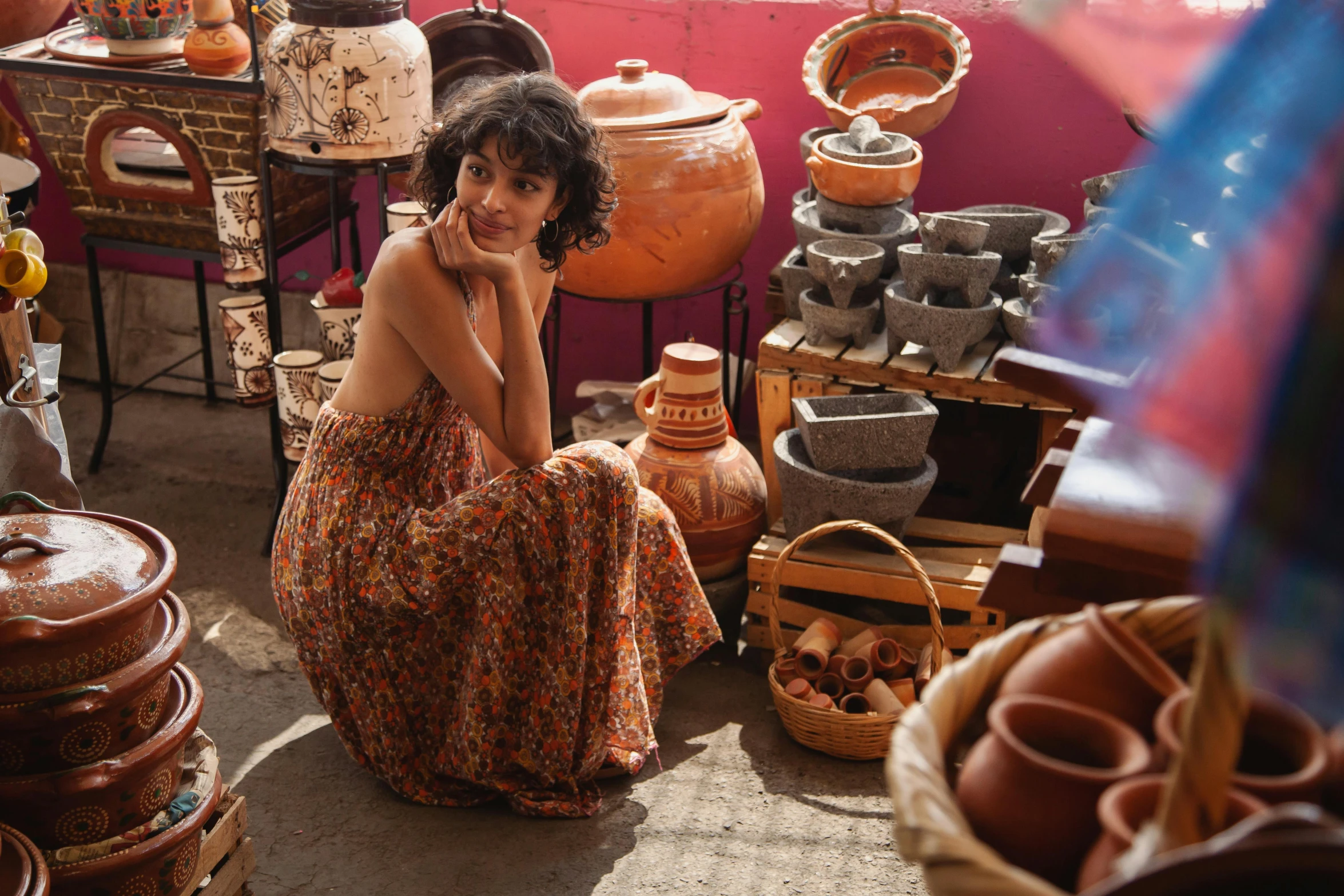 a woman sitting in a room full of pottery, pexels contest winner, beautiful tan mexican woman, sitting on a store shelf, brown, thumbnail