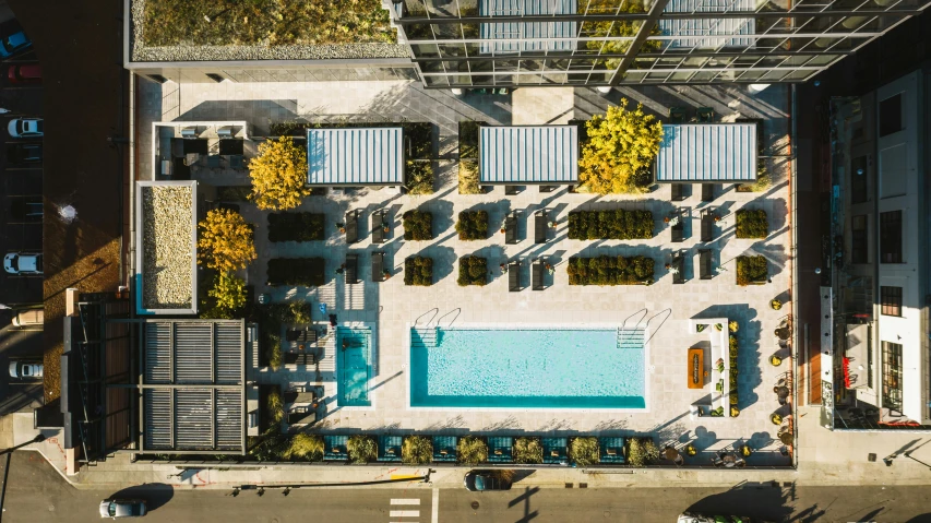 an aerial view of an outdoor swimming pool, by Carey Morris, skyscrapers with greenery, dwell, fall season, square