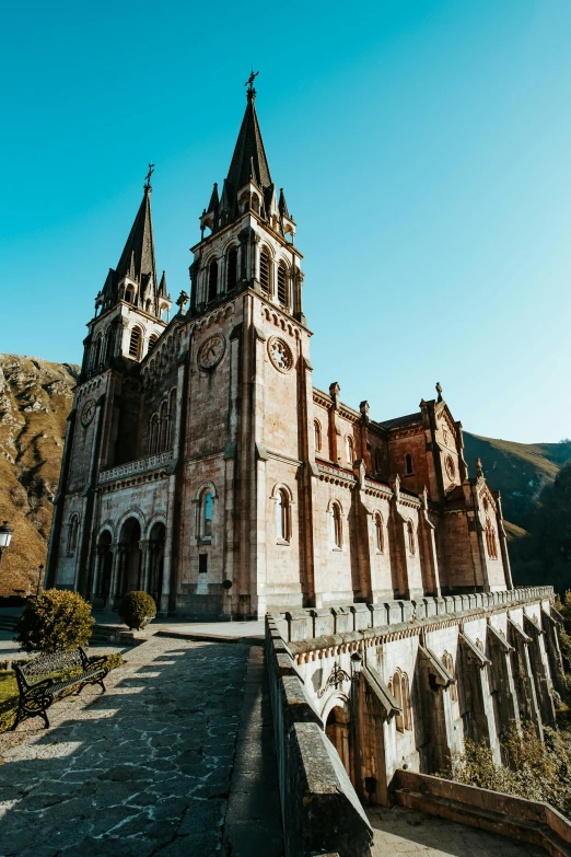 a large church sitting on top of a lush green hillside, an album cover, by Carlo Martini, pexels contest winner, romanesque, ivan bolivian, buttresses, panorama view, color image