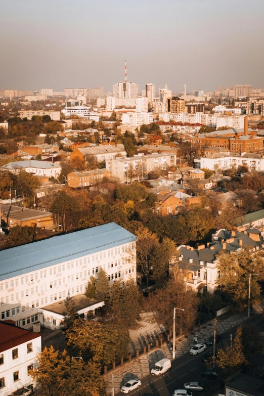 a view of a city from the top of a building, unsplash, socialist realism, rostov city, high res 8k, autumn, square