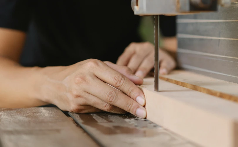 a person using a drill on a piece of wood, trending on pexels, arts and crafts movement, saws, profile image, rectangle, lachlan bailey