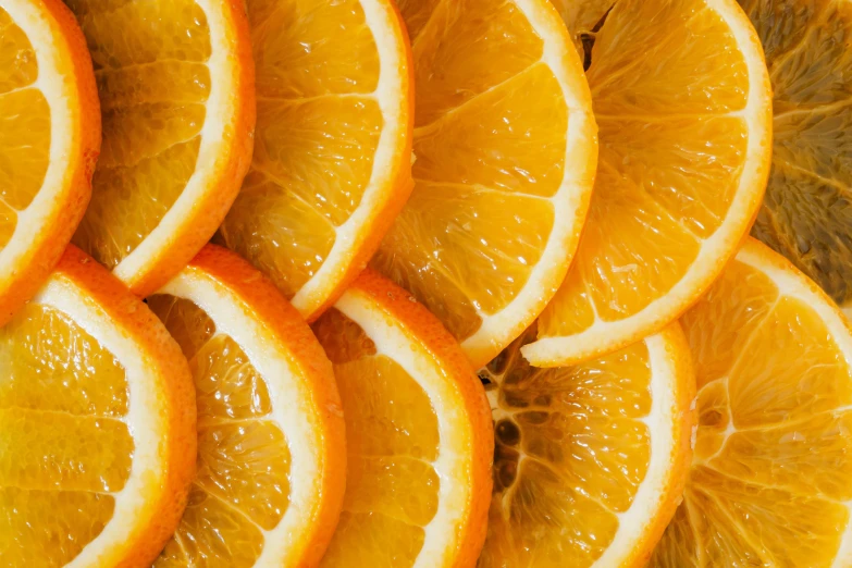 a pile of sliced oranges sitting on top of a table, pexels, process art, background image, thumbnail, high-resolution, lemonade