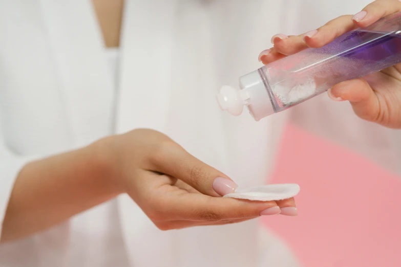 a close up of a person holding a bottle of toothpaste, by Olivia Peguero, trending on pexels, avatar image, smooth pink skin, spraying liquid, shoulder