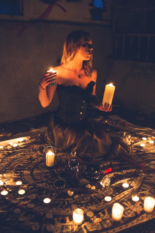 a woman sitting on a rug surrounded by candles, trending on pexels, renaissance, necromancer sorceress, gothic clothing, a seance, hazy