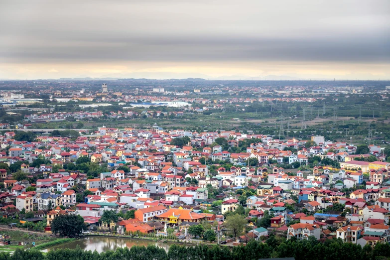 a view of a city from the top of a hill, by Daniel Lieske, pexels contest winner, vietnam, indore, red roofs, slightly pixelated