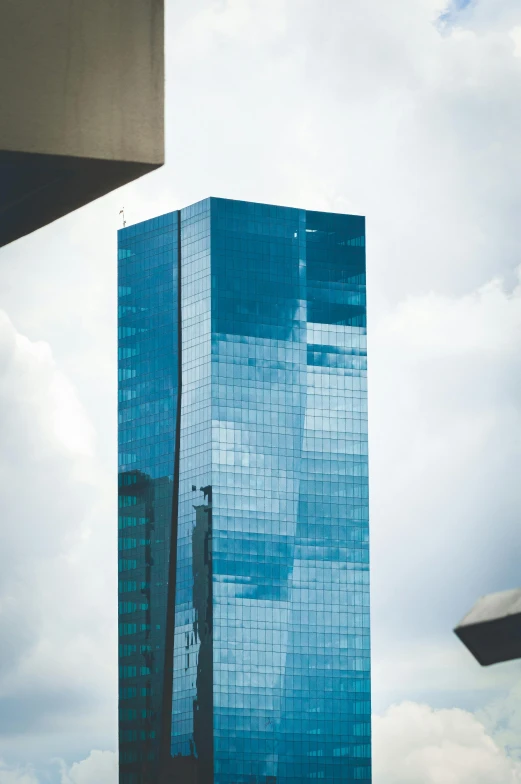 a couple of tall buildings sitting next to each other, pexels contest winner, modernism, colombian, reflective glass, ((monolith)), blue toned