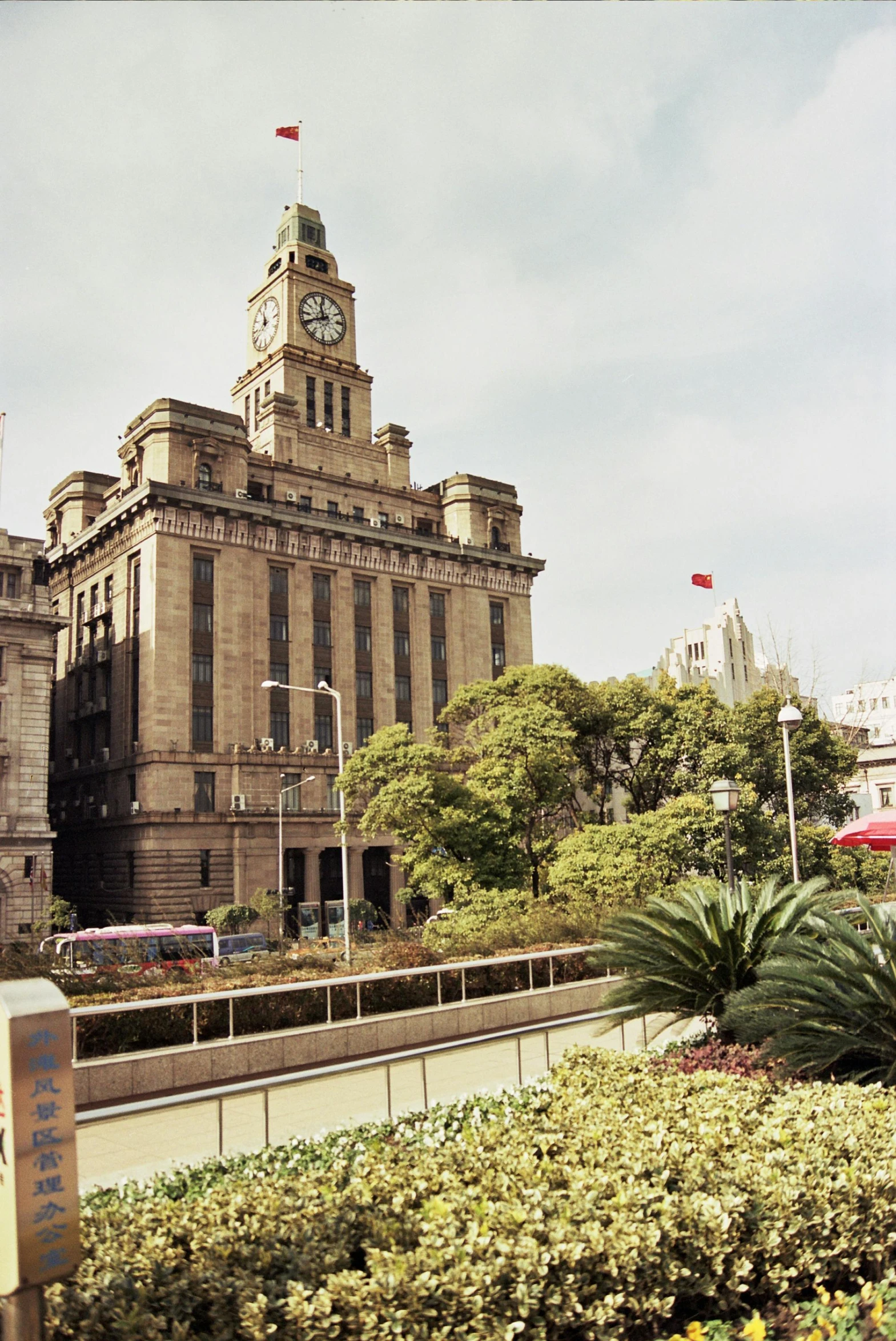 a large building with a clock tower on top of it, inspired by Zhang Sengyao, stalinist architecture, skyscrapers with greenery, town hall, taken in the mid 2000s