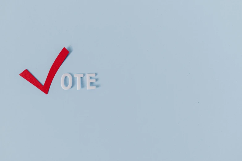 a piece of paper with the word vote cut out of it, by Carey Morris, pexels contest winner, conceptual art, blue or red, victory, simplistic, model