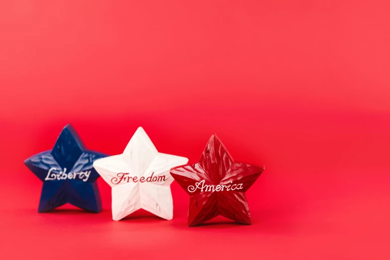 three red, white and blue stars on a red background, inspired by Tracey Emin, trending on unsplash, porcelain holly herndon statue, product photo, freedom, red writing