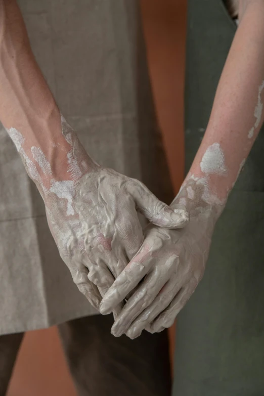 a couple of people that are holding hands, inspired by Sarah Lucas, trending on pexels, process art, porcelain looking skin, covered in white flour, skincare, ignant