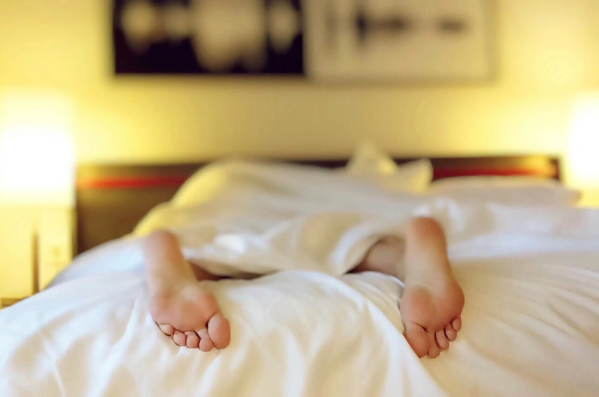 a close up of a person's feet on a bed, pexels, happening, sleepy expression, vibrating, face down, ilustration