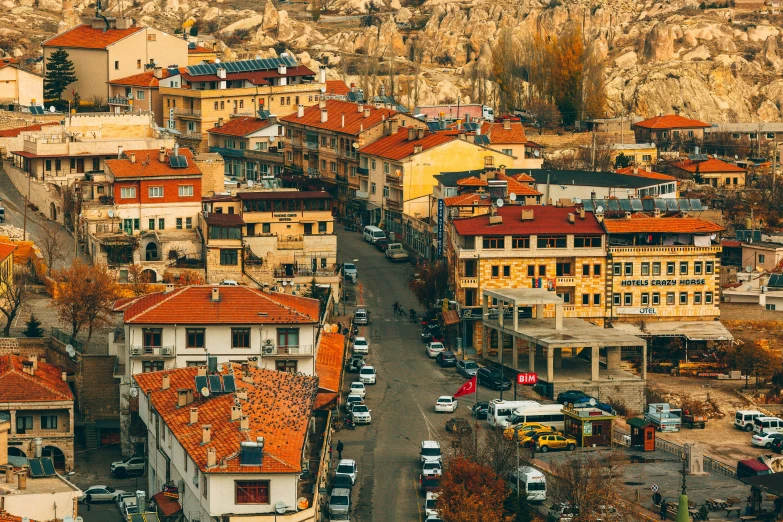 an aerial view of a town with a mountain in the background, by Ibrahim Kodra, pexels contest winner, art nouveau, square, orange roof, beige, turkey