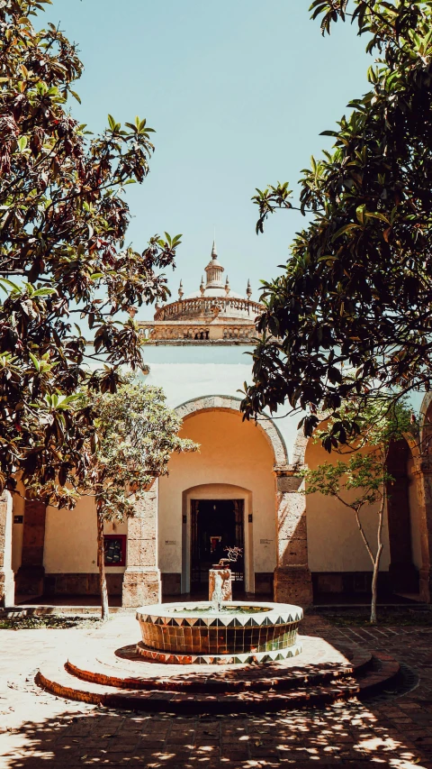 a courtyard with a fountain surrounded by trees, pexels contest winner, quito school, arched doorway, thumbnail, summer day, profile image