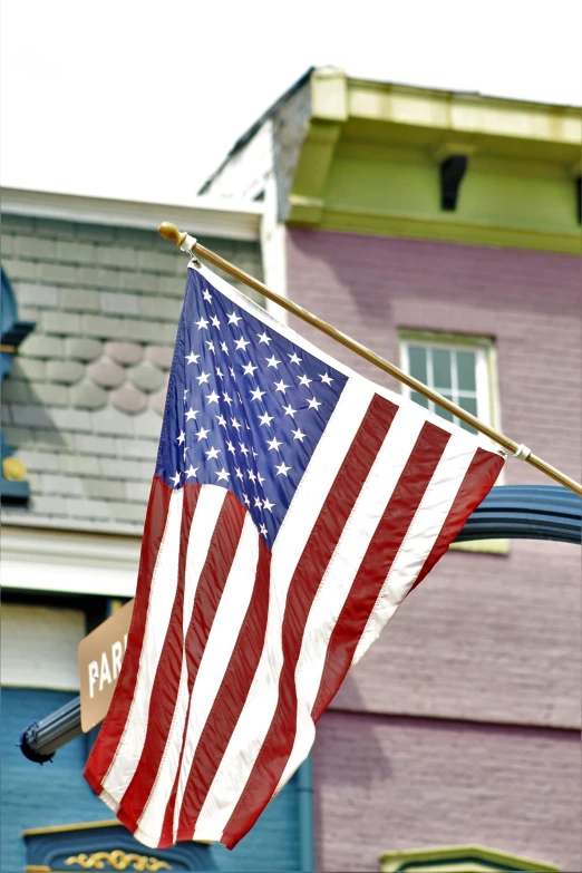 an american flag on a pole in front of a building, slide show, square, purple, ballard