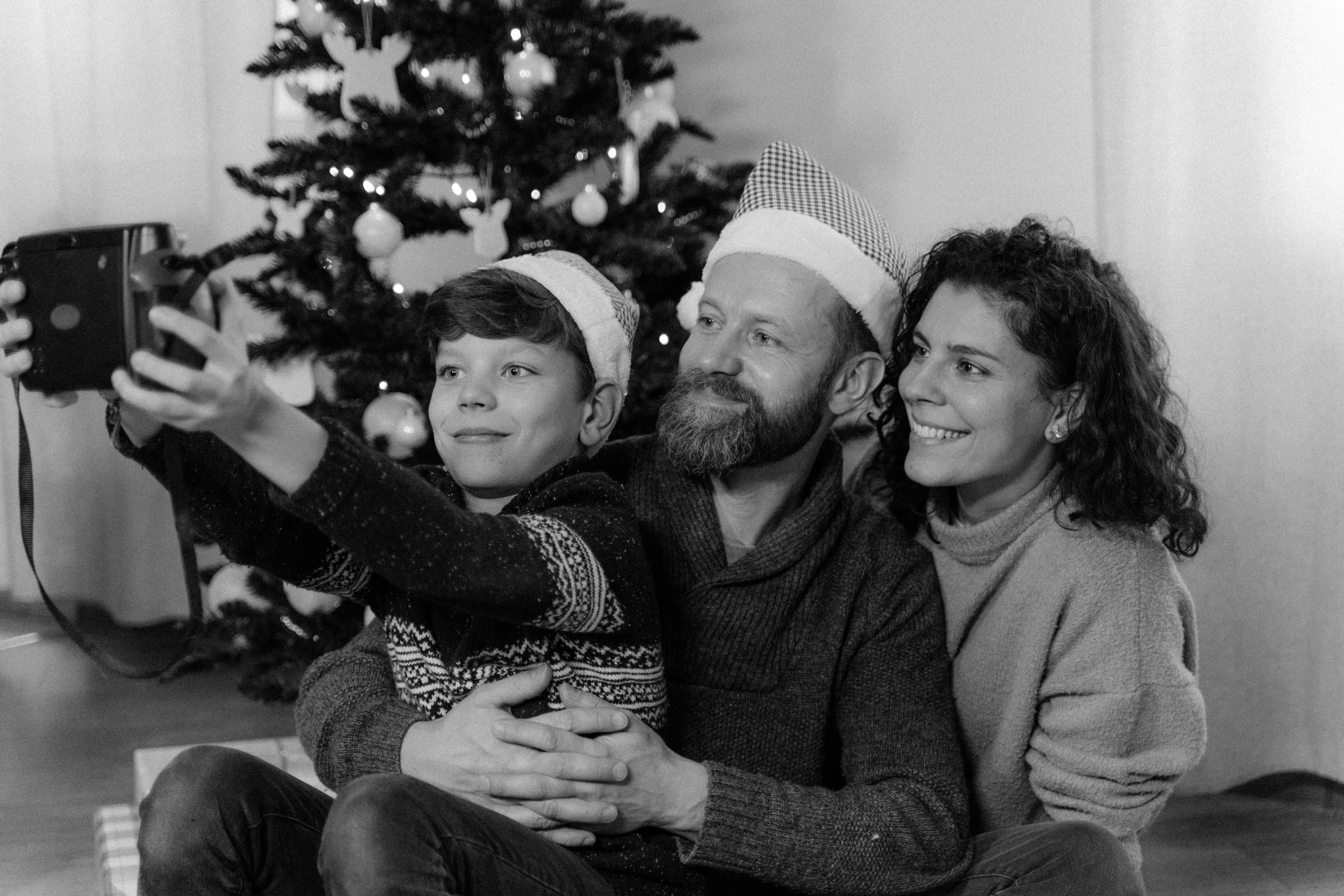 a black and white photo of a family taking a selfie, a black and white photo, christmas tree, istockphoto, 8k octan advertising photo, home video footage