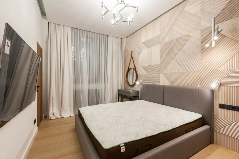 a bed sitting inside of a bedroom on top of a hard wood floor, by Adam Marczyński, pexels contest winner, light and space, light beige pillows, wallpaper on the walls, neo kyiv, slim build