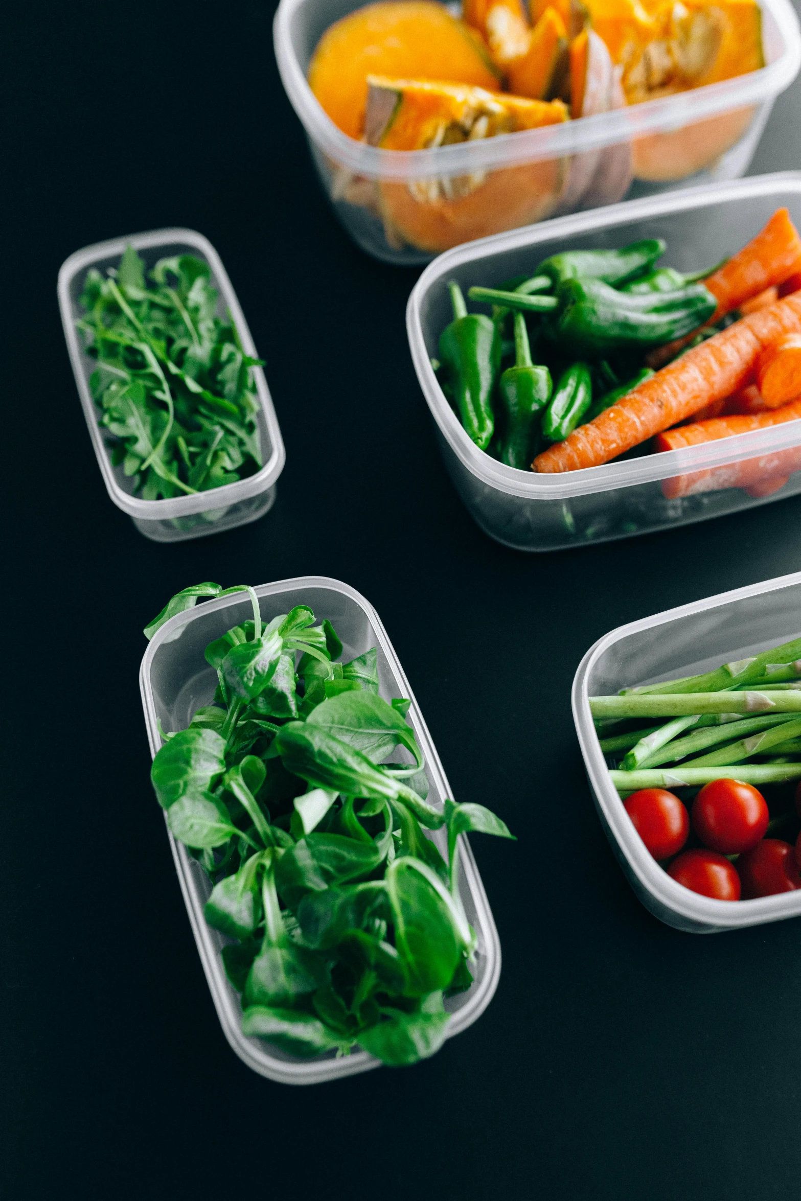 a table topped with plastic containers filled with vegetables, unsplash, plasticien, multiple stories, detailed product shot, dark. no text, 8l