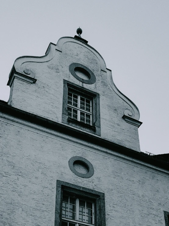 a black and white photo of a building, inspired by Michelangelo Unterberger, unsplash contest winner, baroque, alpine architecture, white and grey, goth aesthetic, small windows