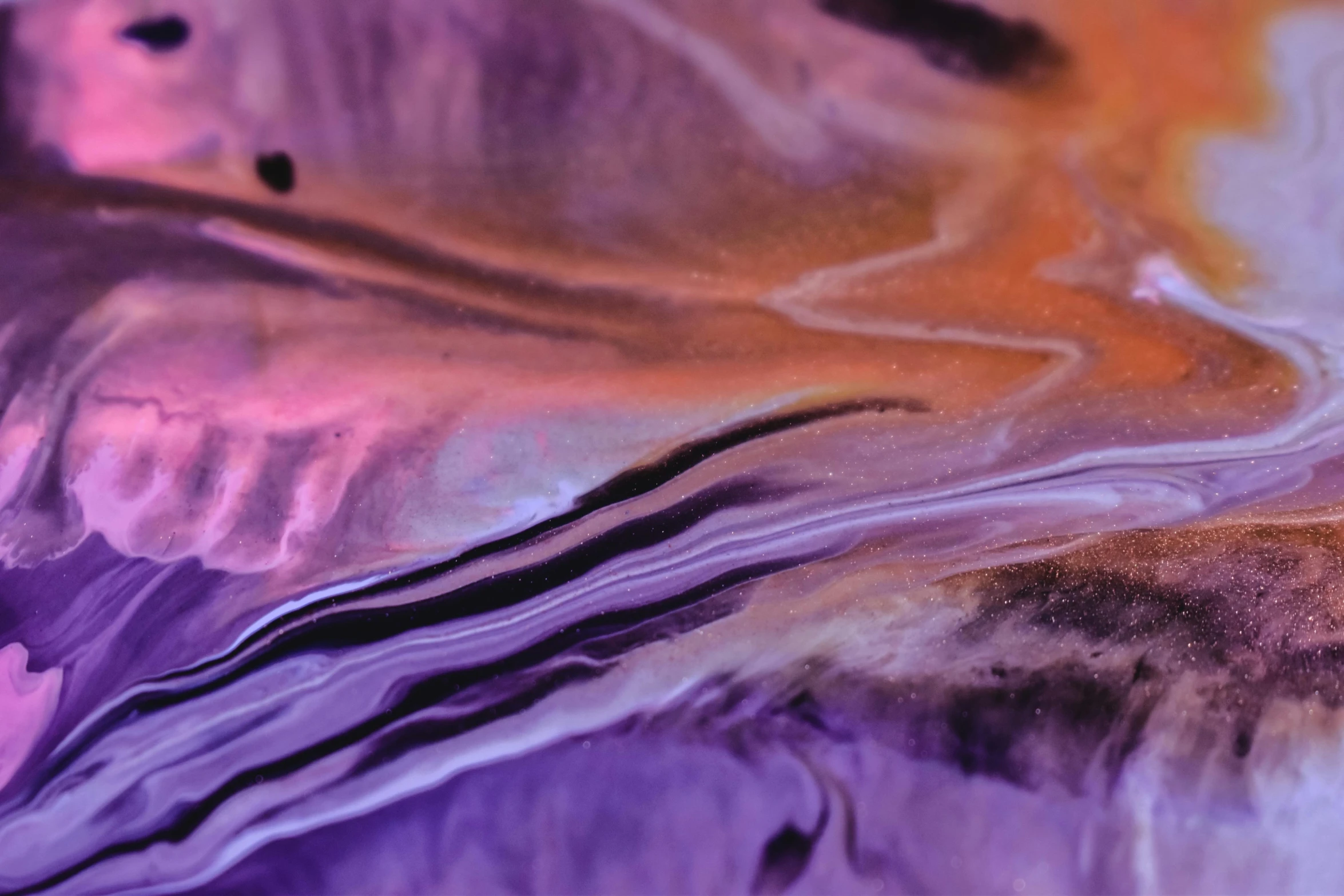 a close up of a piece of art on a table, inspired by Anna Füssli, trending on pexels, lyrical abstraction, purple liquid, lsd waves, some purple and orange, iridescent metals