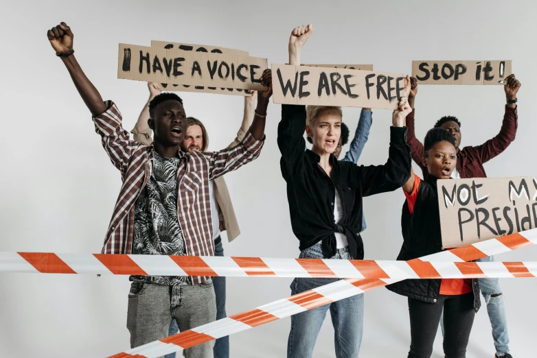 a group of people holding up protest signs, pexels, renaissance, avatar image, background image, cardboard cutout, striped