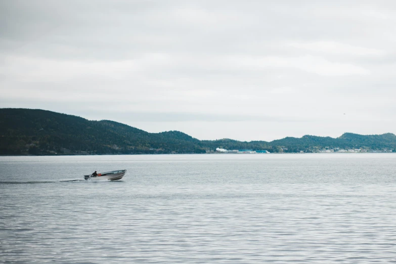 a small boat in the middle of a large body of water, by Jesper Knudsen, pexels contest winner, purism, haida gwaii, 2 5 6 x 2 5 6 pixels, urban surroundings, hunting