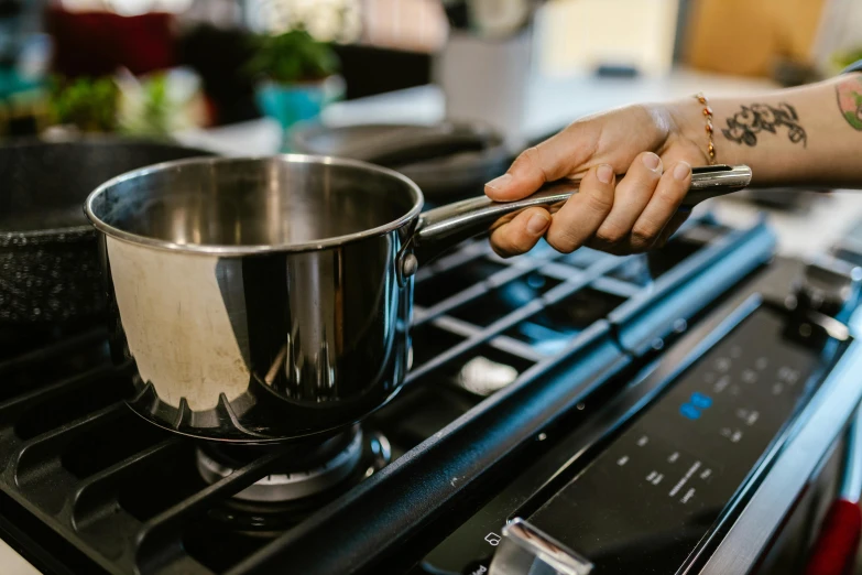 a close up of a person cooking on a stove, profile image, fan favorite, stainless steel, soup