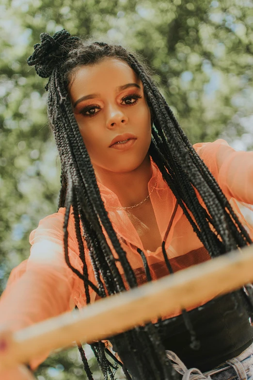 a woman with dreadlocks holding a baseball bat, an album cover, trending on pexels, long black braided hair, doja cat, portrait mode photo, straw