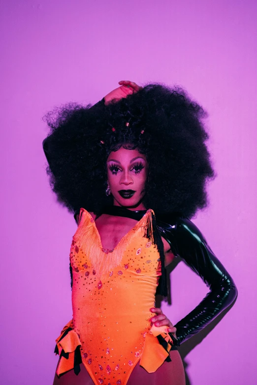 a woman with an afro posing for a picture, an album cover, drag light bombs, tilt and orange, vixen, purple glow