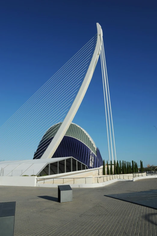 a view of a bridge with a building in the background, inspired by Pedro Álvarez Castelló, modernism, futuristic sport arena, lead - covered spire, curved lines, seen from afar