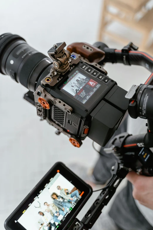 a close up of a person holding a camera, sci - fi equipment, walking towards the camera