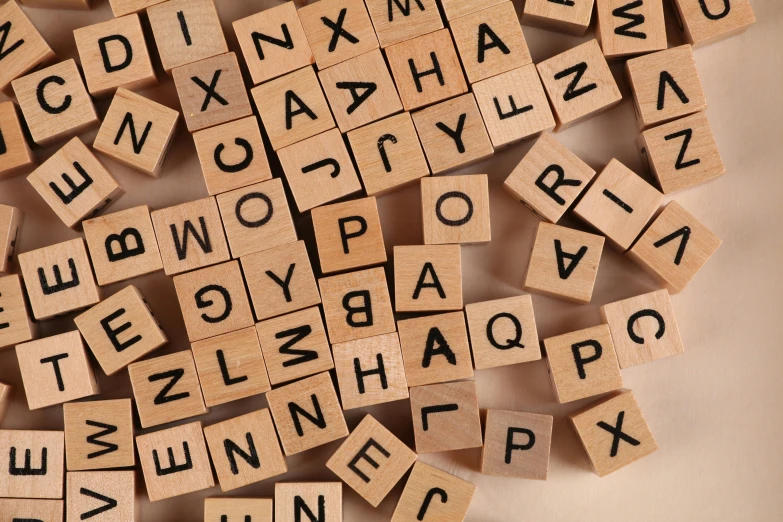 a pile of scrabbles sitting on top of a table, by Emma Andijewska, unsplash, letterism, square, brown, educational, 15081959 21121991 01012000 4k