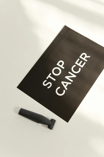 a sign that says stop cancer next to a knife, a poster, by Julia Pishtar, all black matte product, shaved, wide high angle view, profile image