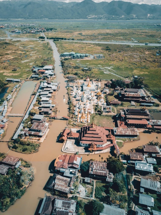 an aerial view of a flooded village, unsplash contest winner, hurufiyya, large temples, low quality photo, helicopter footage over city, sri lanka