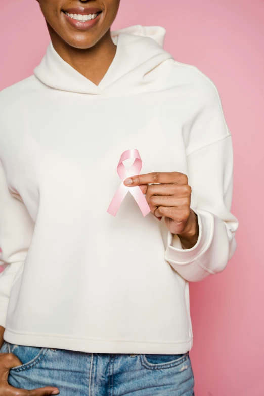 a woman in a white hoodie holding a pink ribbon, no text, ((pink)), multiple stories, vanilla