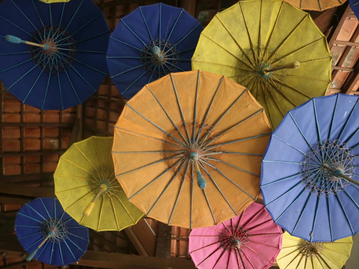 a bunch of colorful umbrellas hanging from the ceiling, inspired by Ai Weiwei, unsplash, laos, avatar image, peaked wooden roofs, thumbnail