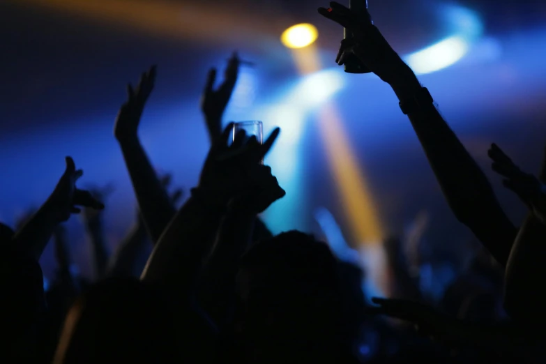 a crowd of people raising their hands at a concert, an album cover, pexels, drinking, avatar image, blue, nightclub