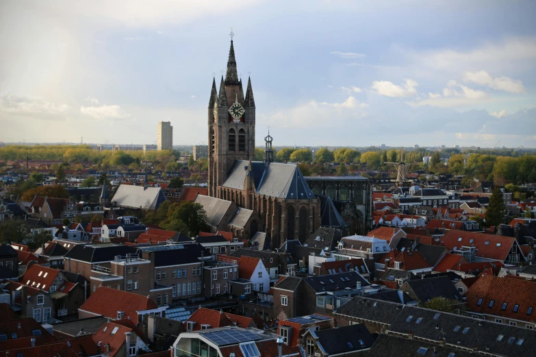 an aerial view of a city with a clock tower, by Jan Tengnagel, pexels contest winner, happening, delft, brown, sky line, gothic cathedral