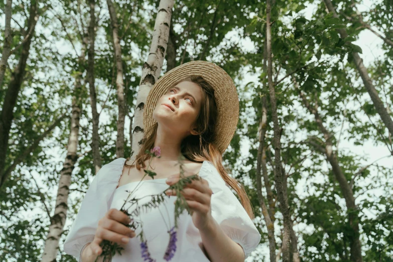 a woman standing in a forest holding a flower, pexels contest winner, renaissance, white straw flat brimmed hat, avatar image, low angle photo, ad image