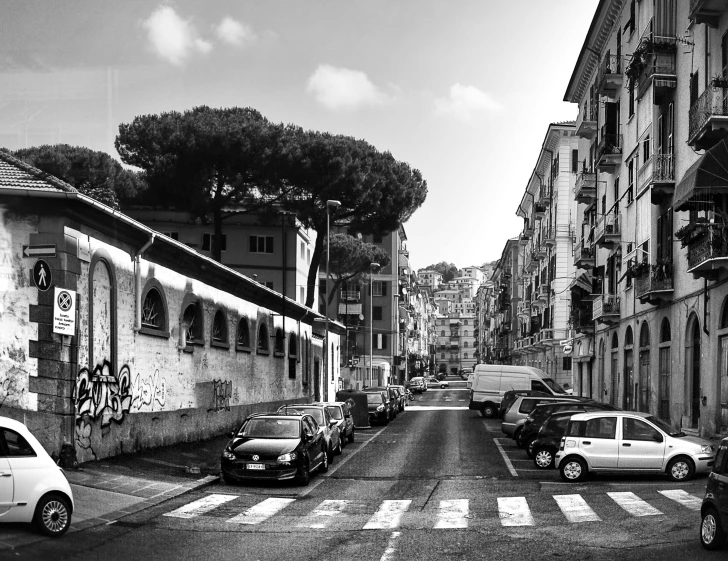 a black and white photo of a city street, by Patrick Pietropoli, pexels contest winner, street art, gulf of naples, parking in the street, panoramic, on a bright day