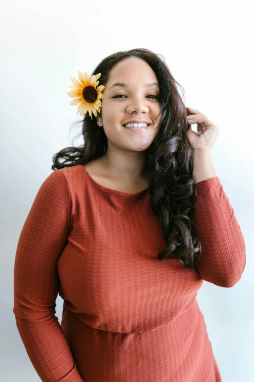 a woman with a flower in her hair, an album cover, pexels contest winner, alluring plus sized model, brown sweater, alanis guillen, bright and sunny