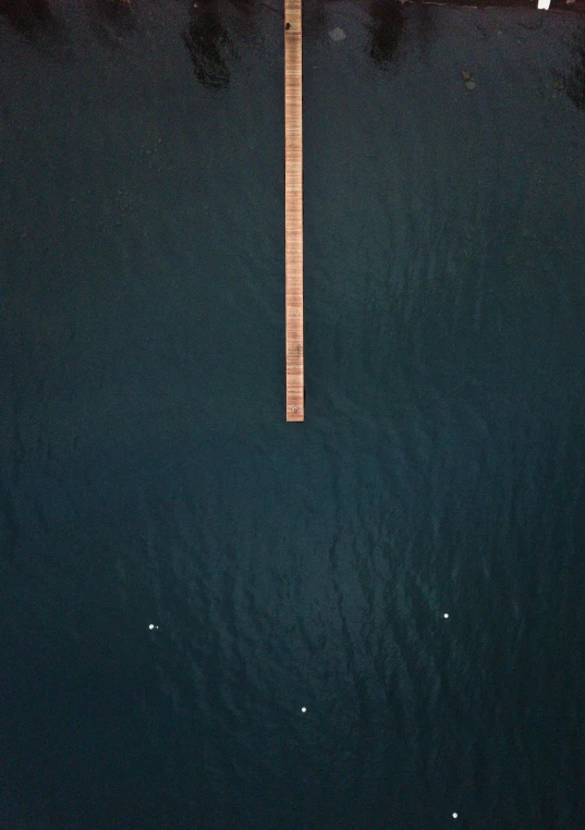 a dock in the middle of a body of water, by Jan Rustem, minimalism, birdseye view, dark background”, planets align, boardwalk